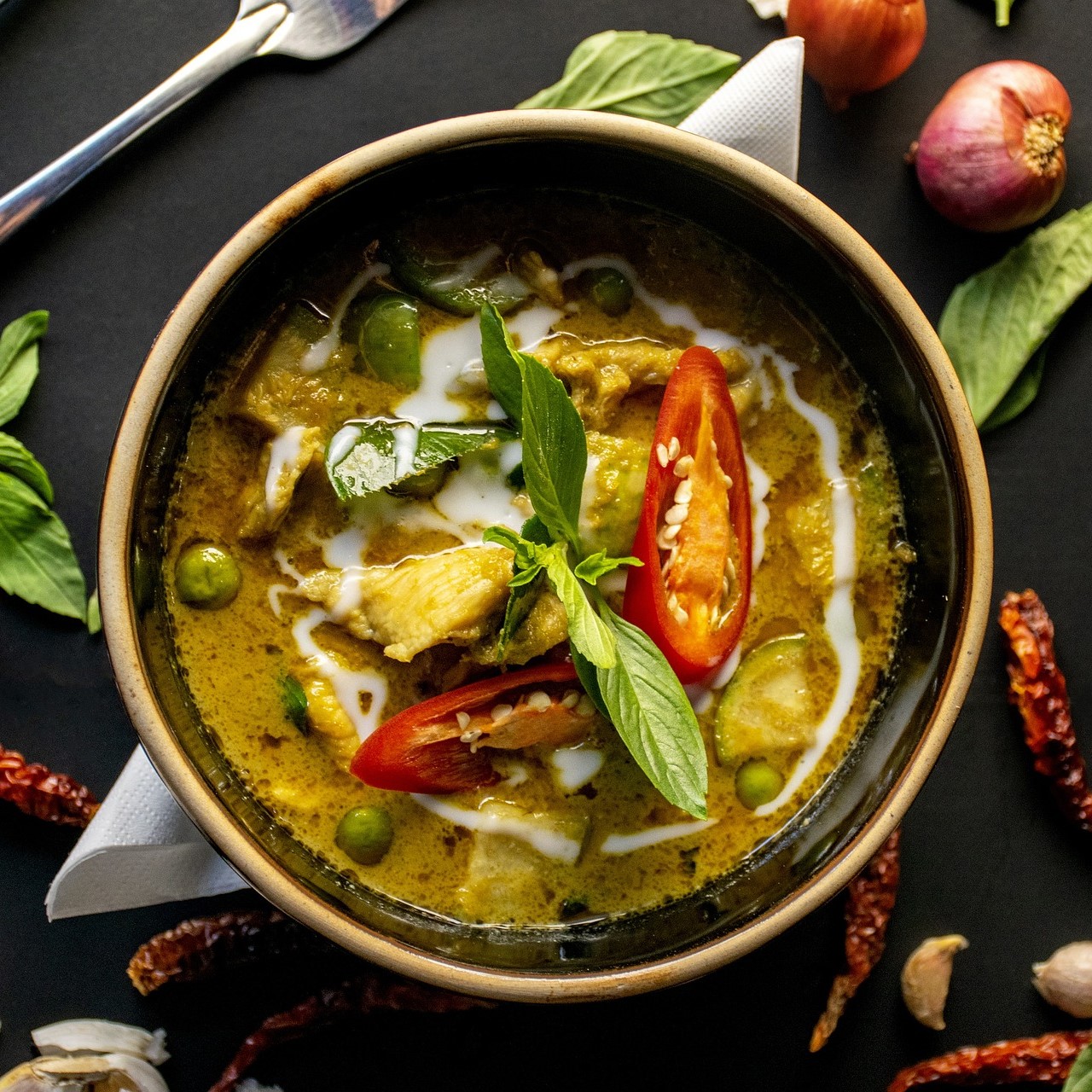 Picture of thai green curry with chilli pepper garnish