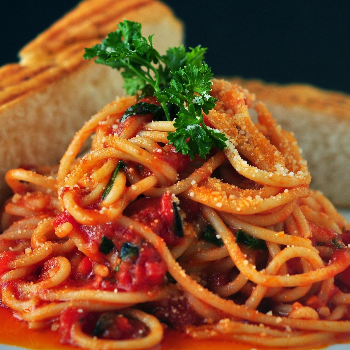 Picture of fresh tomato spaghetti with basil leaves